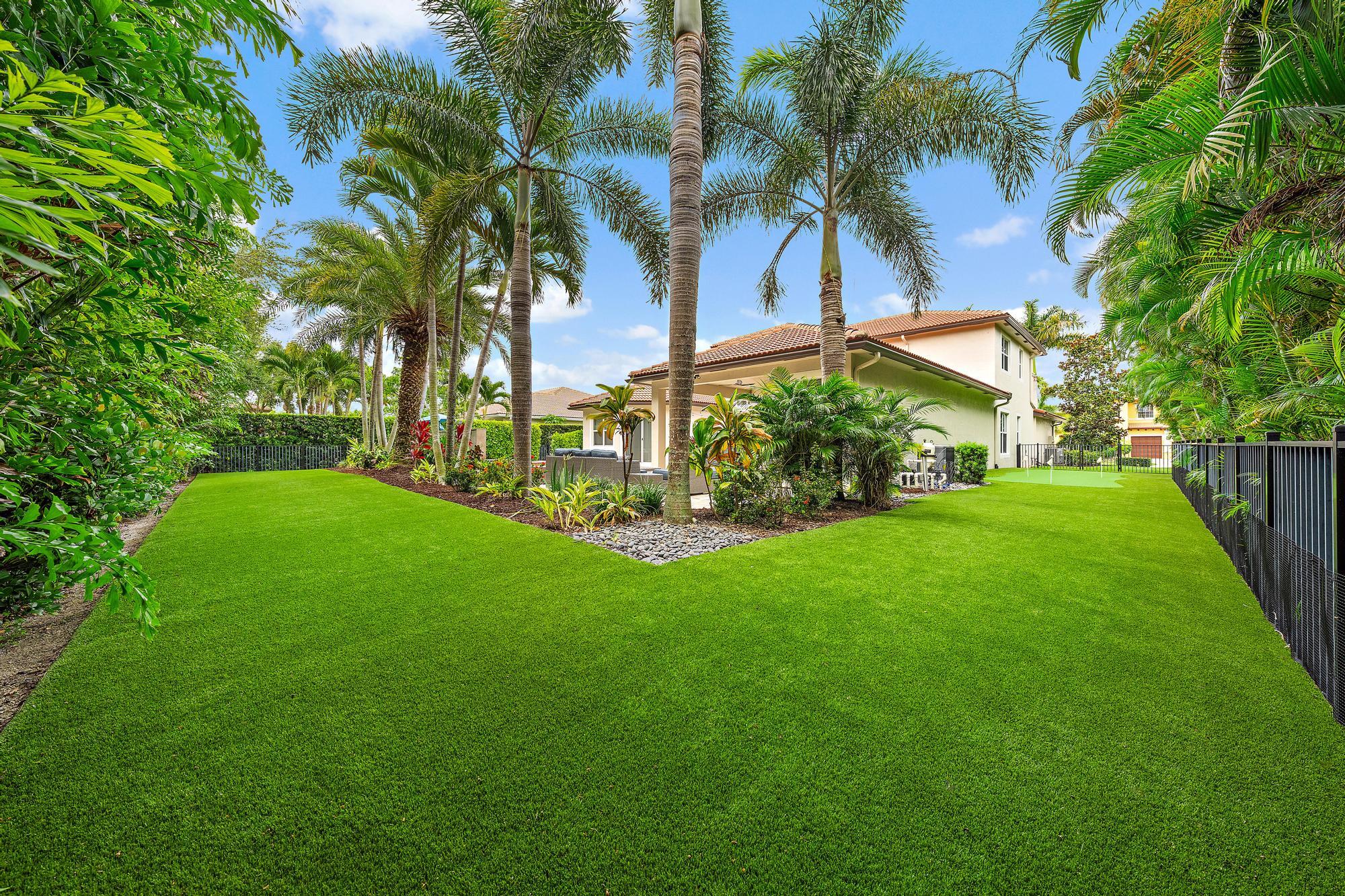 283 Rudder Cay Way Jupiter, FL 33458 - Photo 10 of 41 a view of a yard with a palm trees
