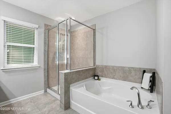 a bathroom with a tub and shower