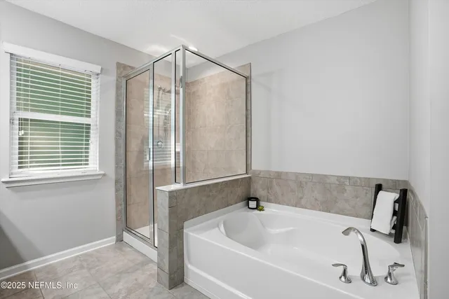 a bathroom with a tub and shower