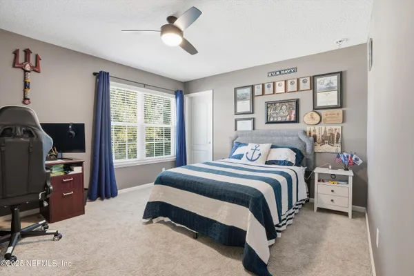 a bedroom with a bed gym equipment and a window