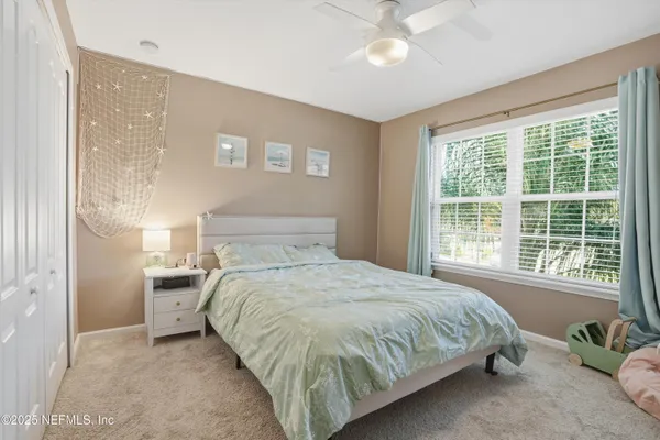 a bedroom with a bed and window