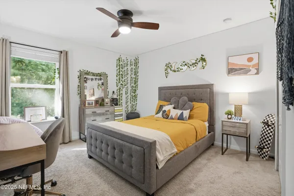 a bedroom with a bed a chandelier and a window