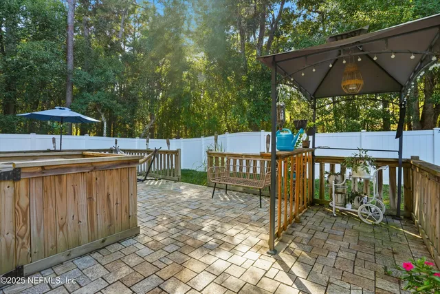 a view of a street with wooden fence