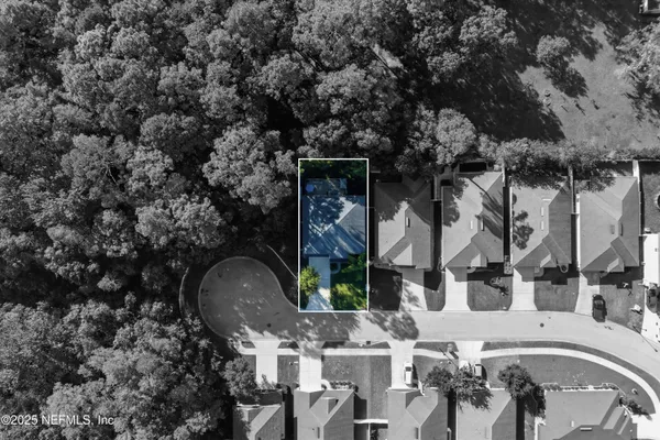 a front view of a house with garden and sitting area