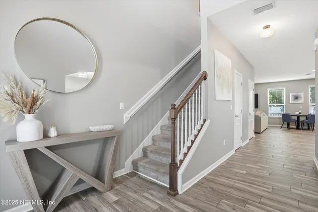 a view of entryway and hall with wooden floor