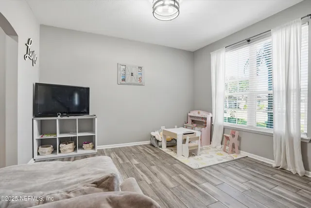 a view of a livingroom with furniture and windows