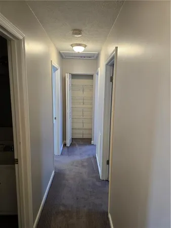 a view of a hallway with wooden shelves