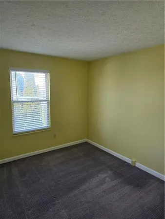 an empty room with a empty space and a window