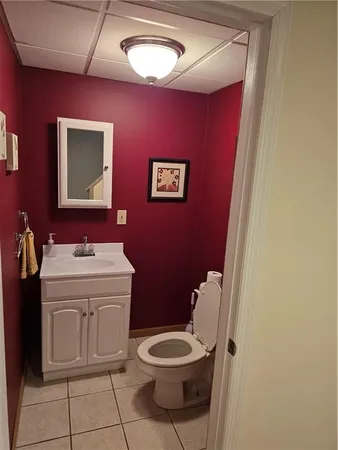 a bathroom with a toilet a sink and mirror