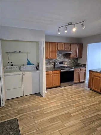 a kitchen with stainless steel appliances granite countertop a sink and cabinets