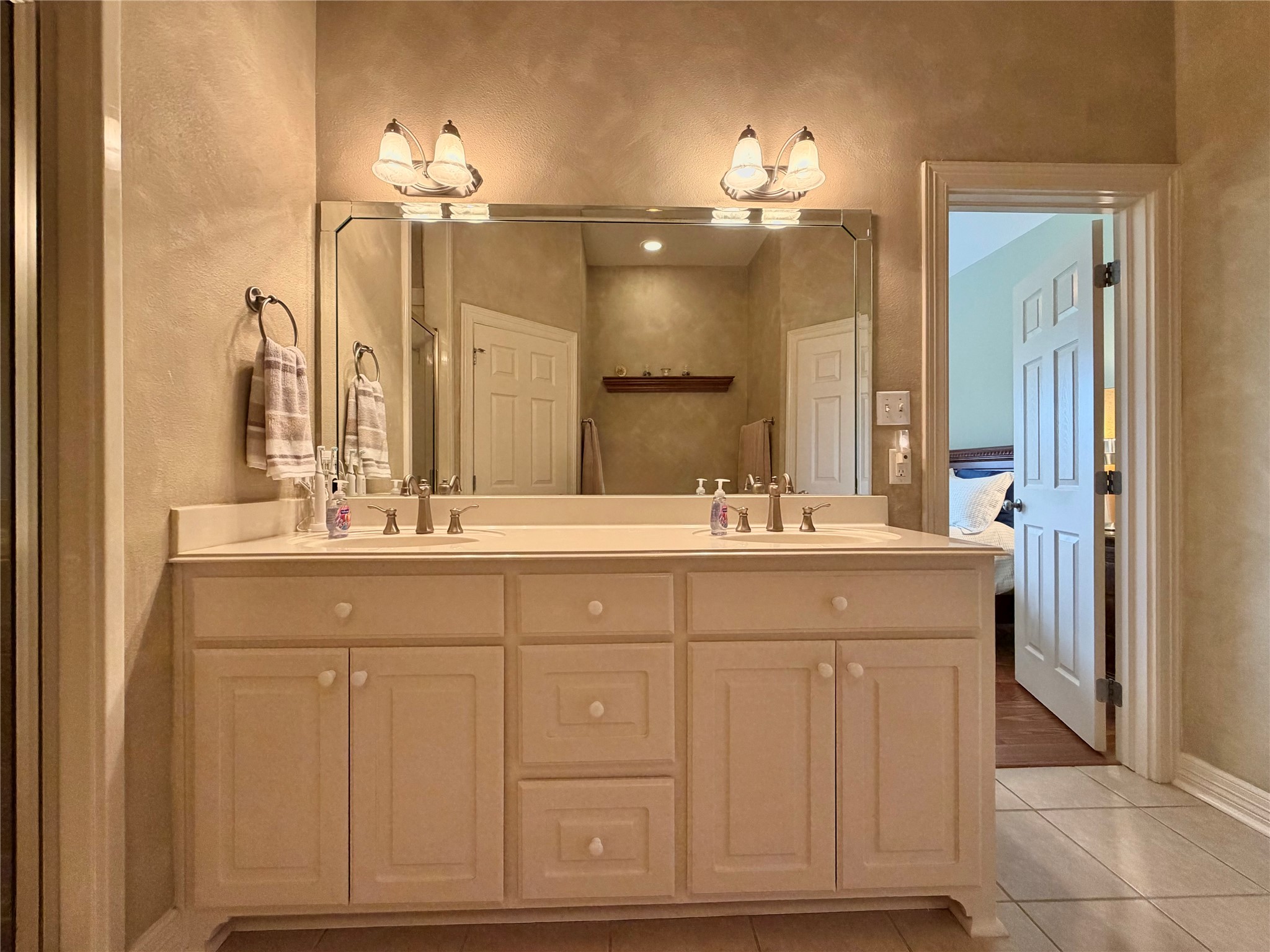 1448 South Blue Bonnet Lane Angleton, TX 77515 - Photo 27 of 43 a bathroom with a sink vanity and a mirror