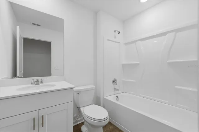 a bathroom with a sink a toilet and a bathtub