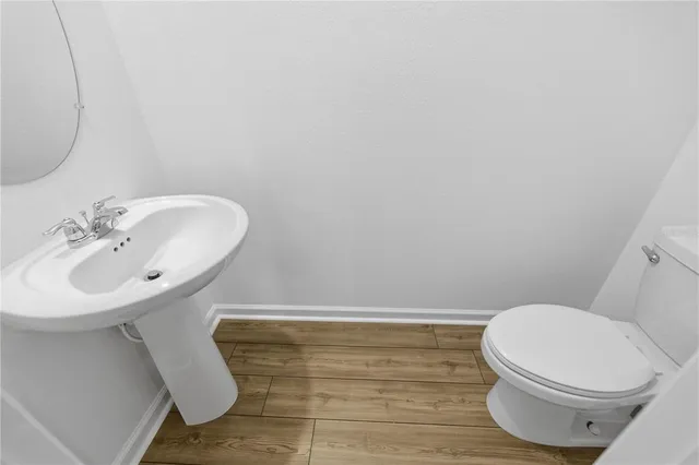 a bathroom with a sink a toilet and mirror