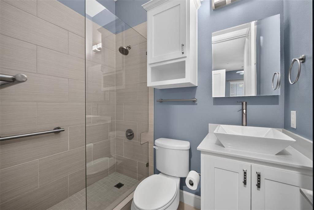 5015 Meridian Lane, Unit 2102 Addison, TX 75001 - Photo 26 of 36 Contemporary bathroom featuring a glass-enclosed shower with tile surround and integrated grab bars