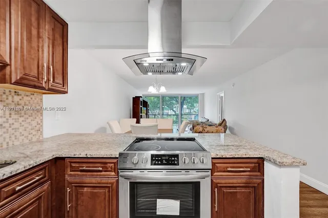 a kitchen with a stove and a white cabinets
