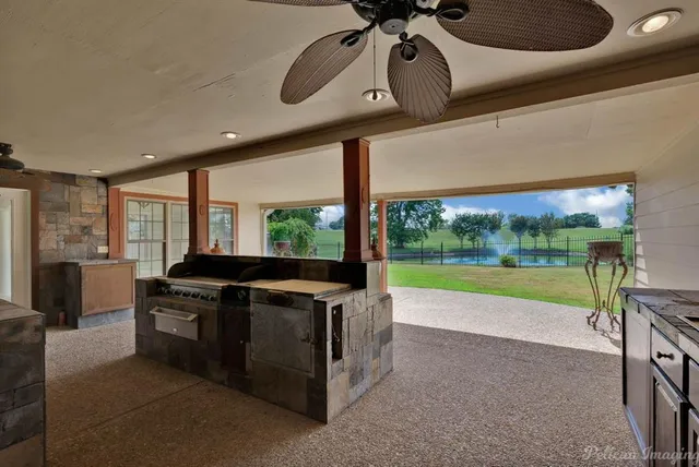 a living room with furniture and a floor to ceiling window