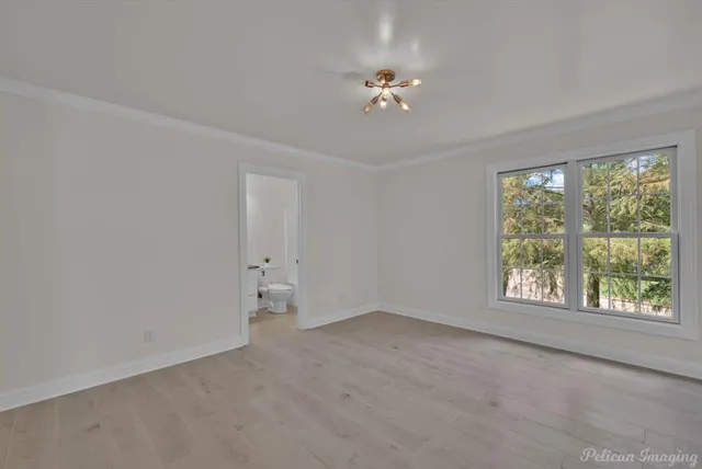 a bathroom with a granite countertop sink a toilet and mirror