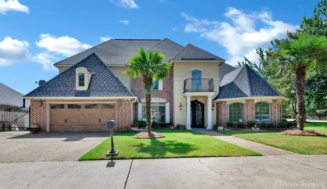 a front view of a house with a garden and plants