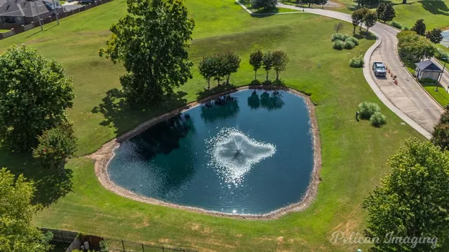 a view of a house with a yard and a garden