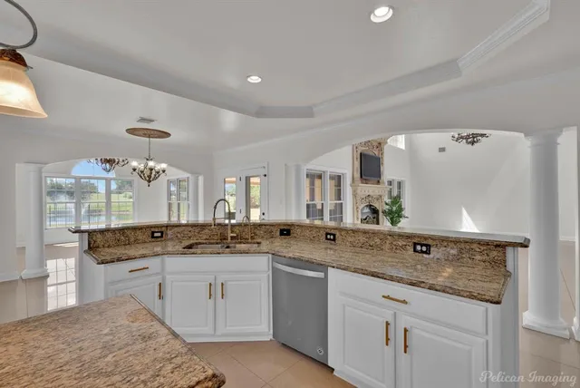 a spacious bathroom with a granite countertop sink and a mirror