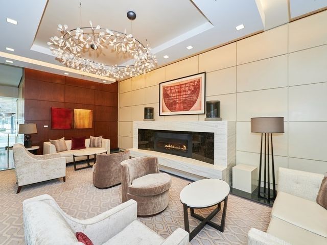 a living room with furniture a table and a fireplace