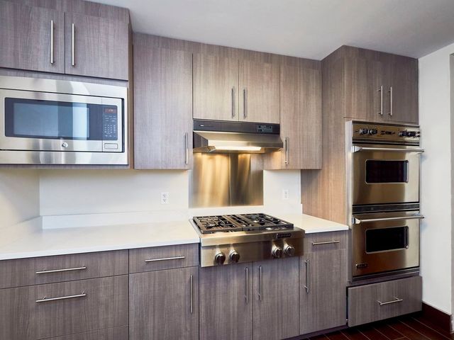 a kitchen with a stove and a microwave