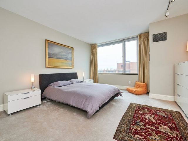 a bedroom with a bed and a couch