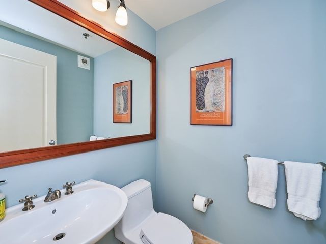 a bathroom with a sink mirror and toilet