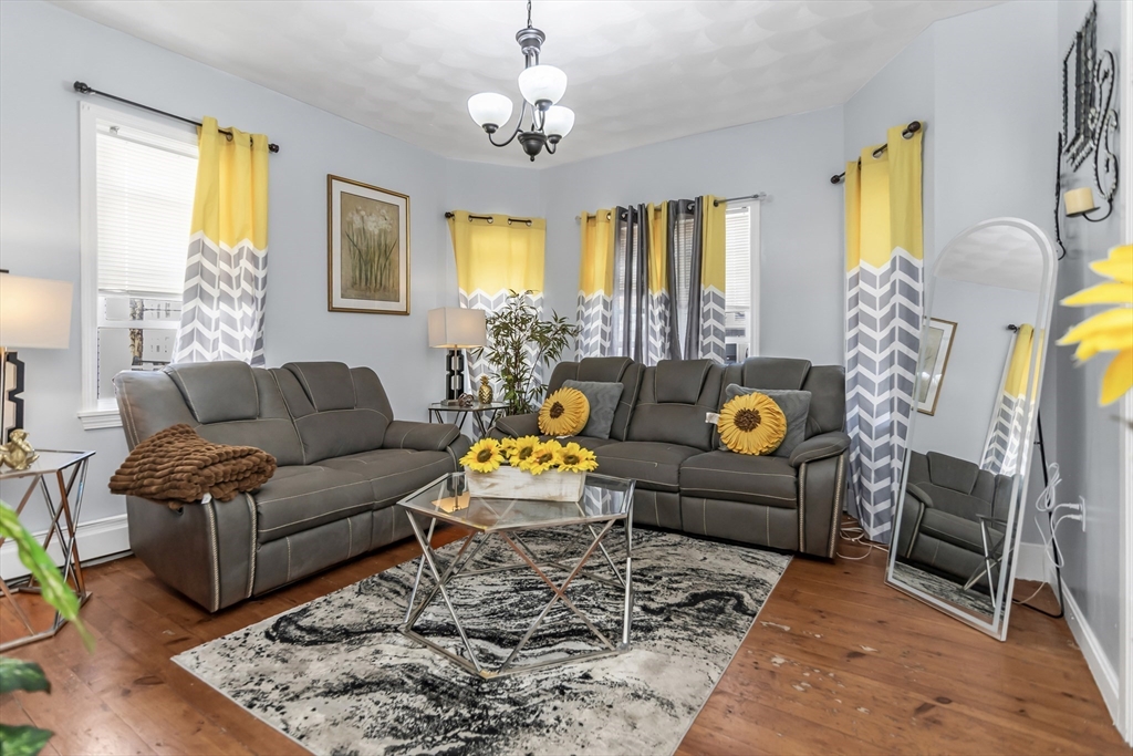 191 Farnham Street Lawrence, MA 01843 - Photo 5 of 31 a living room with furniture and a chandelier