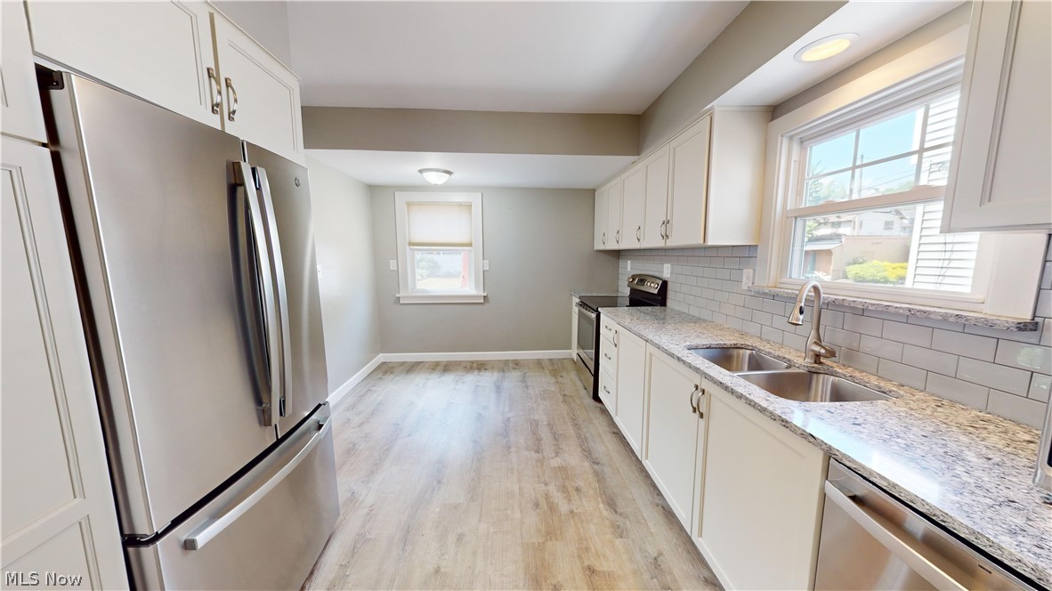 3988 Navahoe Road Cleveland Heights, OH 44121 - Photo 11 of 31 Kitchen with white cabinets, stainless steel appliances, light hardwood / wood-style flooring, and plenty of natural light