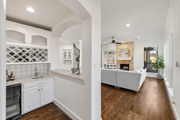 a view of a kitchen with furniture and wooden floor
