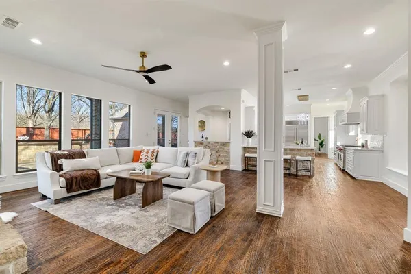 a living room with fireplace furniture and a wooden floor