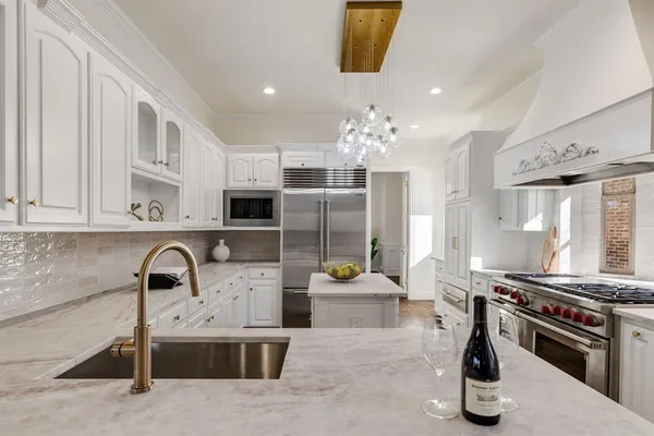 a kitchen with stainless steel appliances granite countertop a sink and a stove