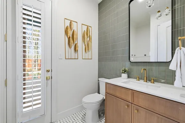 a bathroom with a toilet sink and mirror