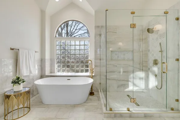 a bathroom with a bathtub and shower