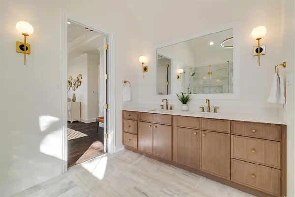 a spacious bathroom with a double vanity sink a mirror and a shower