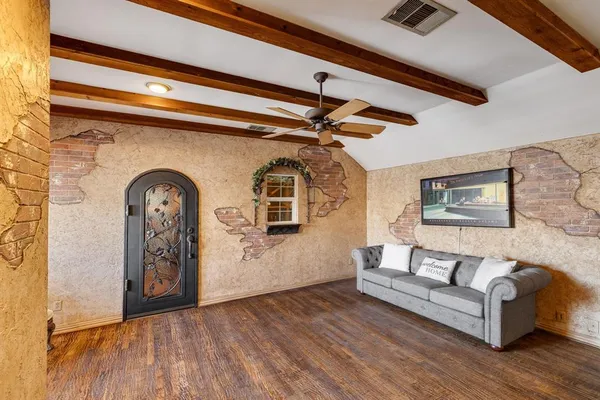 a living room with furniture and wooden floor