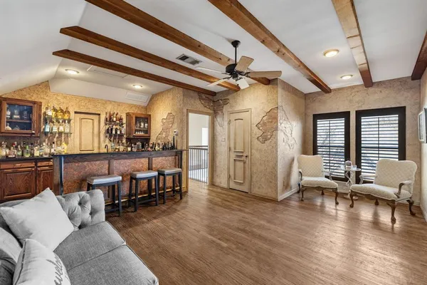 a living room with furniture wooden floor and a table