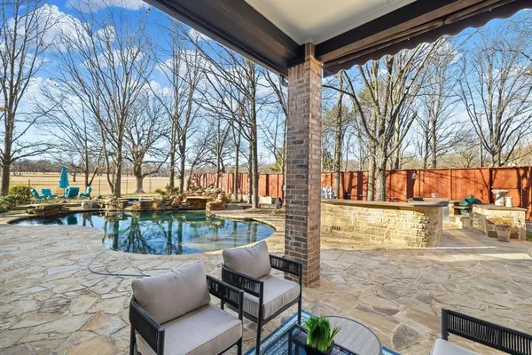 a view of a patio with couches table and chairs and potted plants