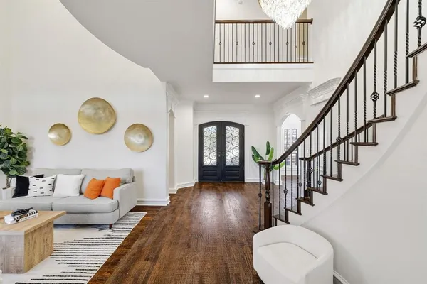 a living room with wooden floors and a rug