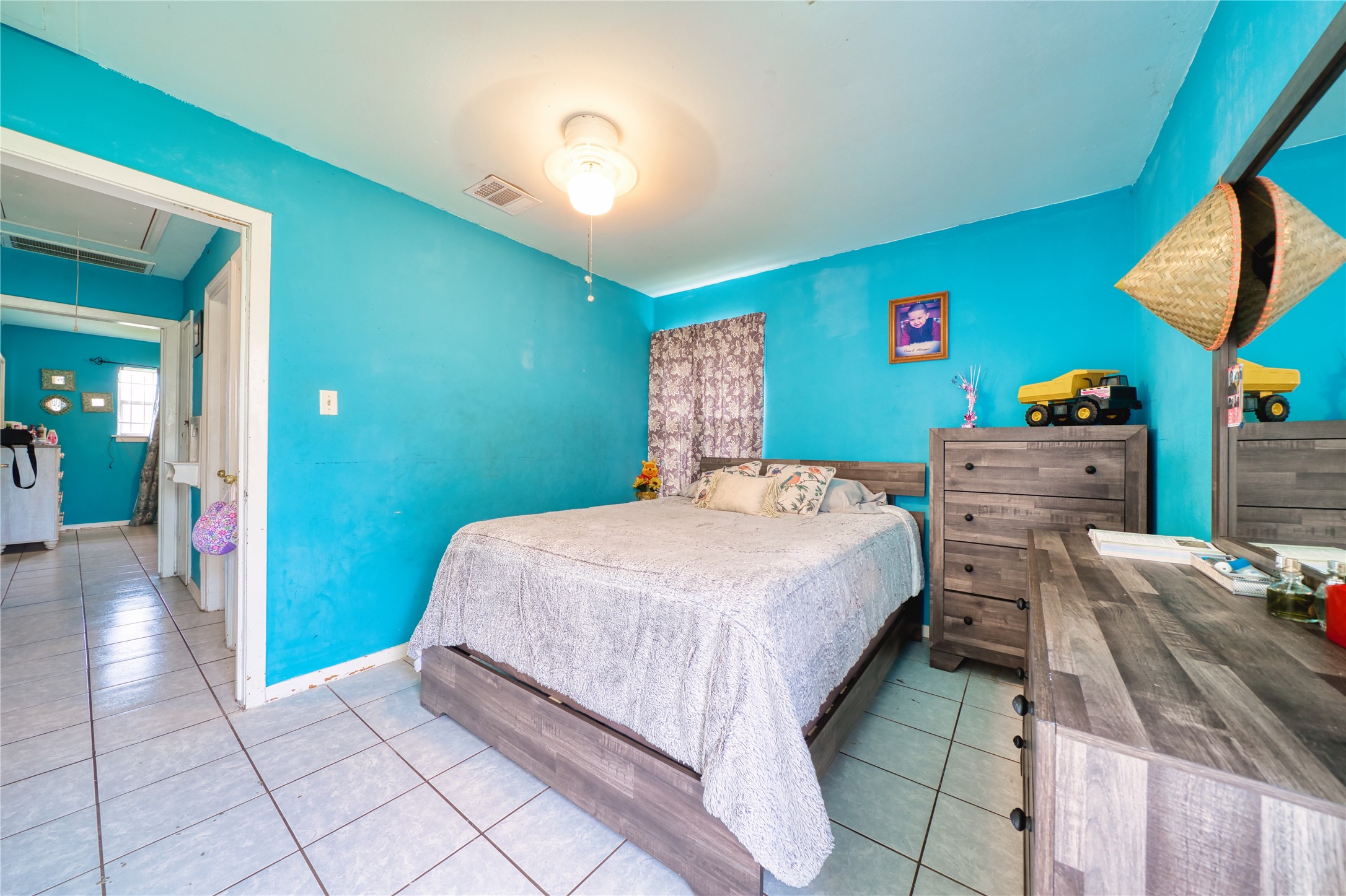4931 Mercedes Lane Houston, TX 77022 - Photo 21 of 29 a bedroom with a bed and a dresser