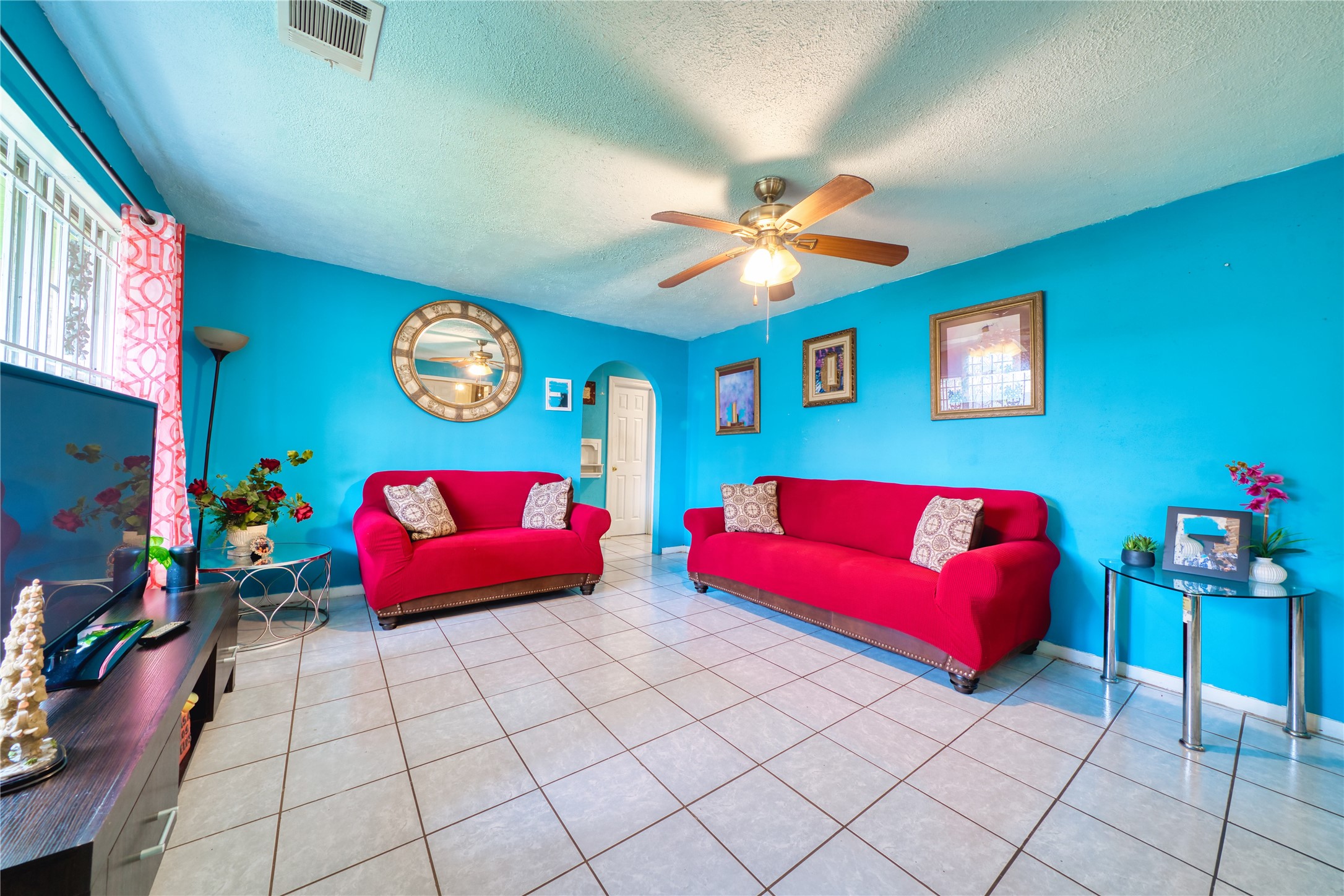 4931 Mercedes Lane Houston, TX 77022 - Photo 6 of 29 a bedroom with furniture and a chandelier