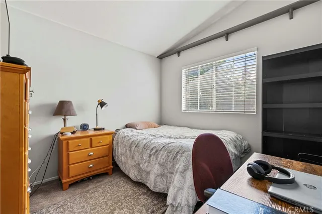 a bedroom with bed and a window