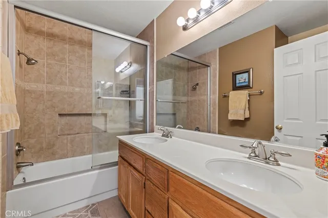a bathroom with a bathtub shower sink and mirror
