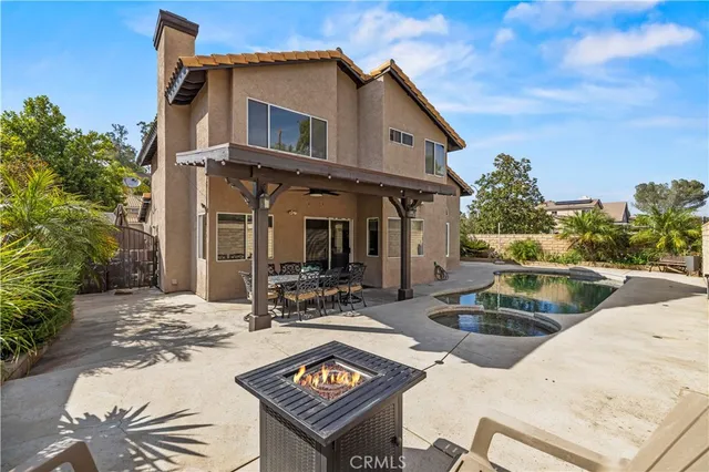 a view of a patio with table and chairs and potted plants