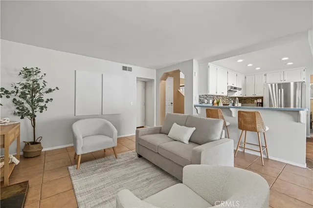 a living room with furniture and a potted plant