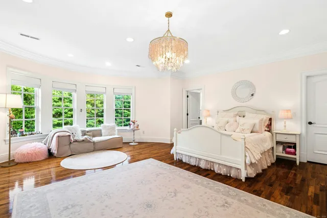 a bedroom with bed and a chandelier