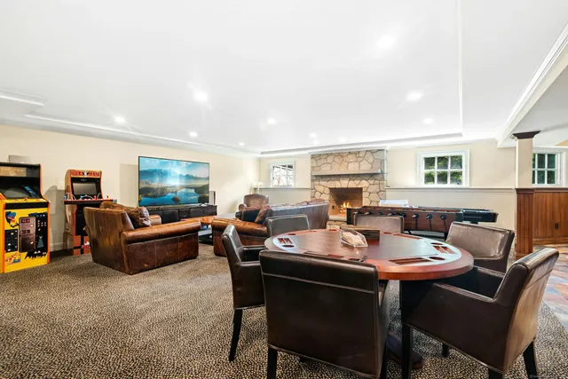 a living room with furniture a flat screen tv and a table