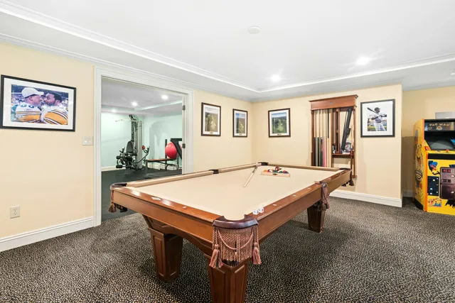 a room with pool table and window