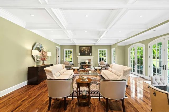a view of a dining room with furniture a chandelier and wooden floor